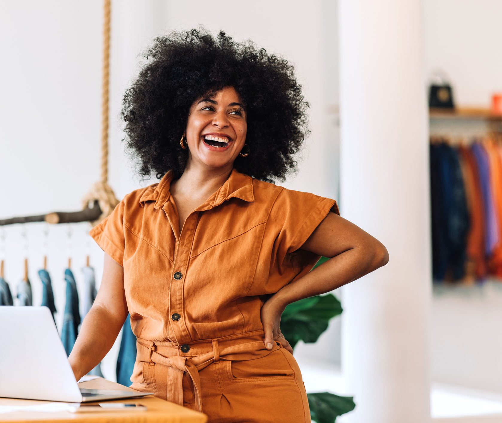 Business owner smiling standing at computer